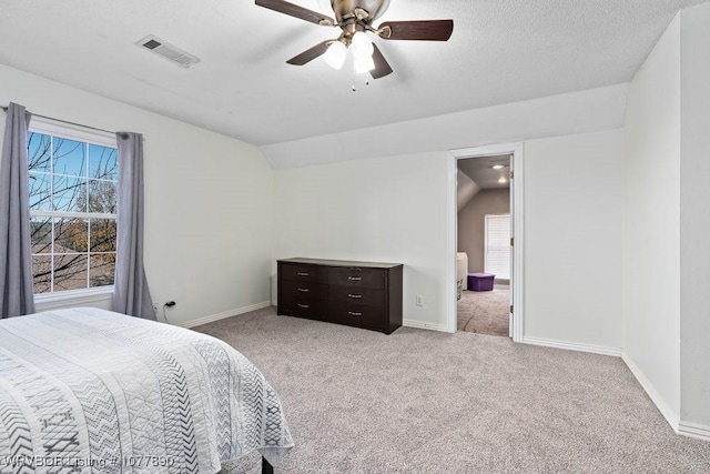 carpeted bedroom featuring ceiling fan, multiple windows, and vaulted ceiling