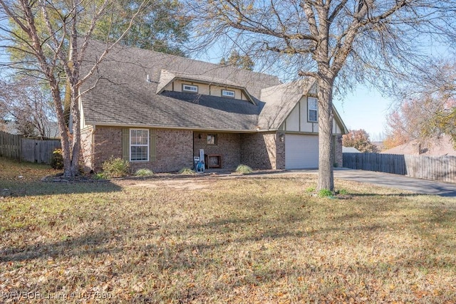 view of front facade with a garage and a front lawn