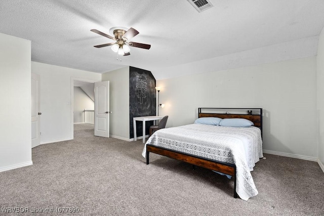 carpeted bedroom with vaulted ceiling, ceiling fan, and a textured ceiling