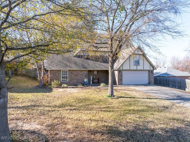 view of front of house with a garage and a front lawn