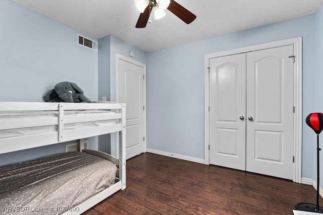 bedroom with a closet, ceiling fan, and dark hardwood / wood-style floors