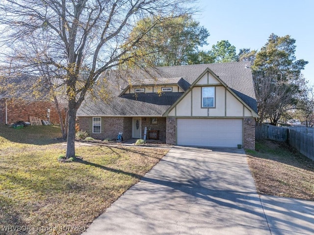 tudor-style house featuring a garage and a front yard