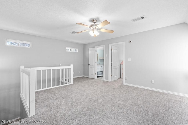 interior space featuring ceiling fan, a healthy amount of sunlight, and a textured ceiling