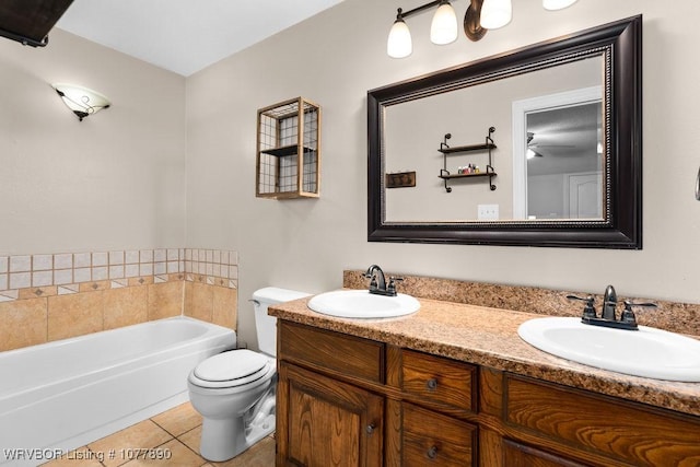 bathroom featuring tile patterned floors, a bathing tub, toilet, and vanity