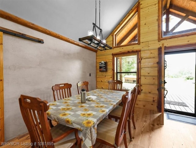 161129 N 4550th Rd, Talihina, OK 74571 - dining area with light wood-style flooring, wooden walls, and high vaulted ceiling