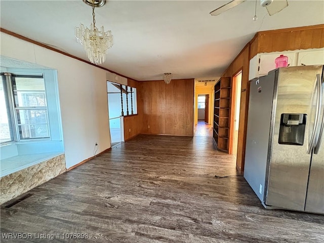 unfurnished dining area featuring crown molding, dark wood-type flooring, and a wealth of natural light