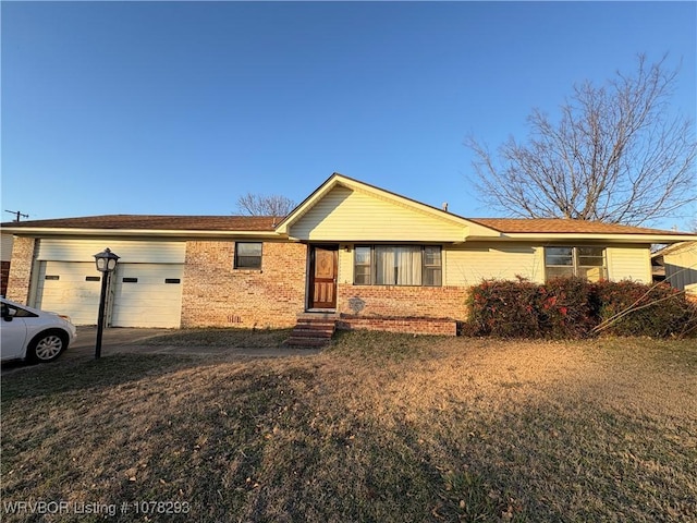 single story home featuring a front yard and a garage