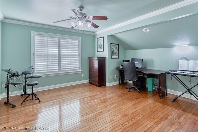 office space with lofted ceiling, hardwood / wood-style floors, ornamental molding, a ceiling fan, and baseboards