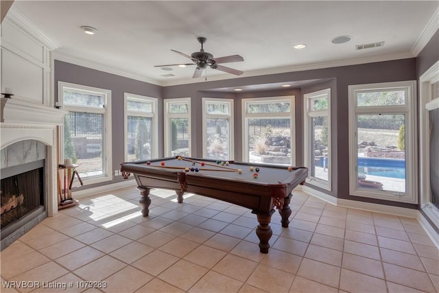 recreation room with light tile patterned floors, baseboards, a high end fireplace, and crown molding