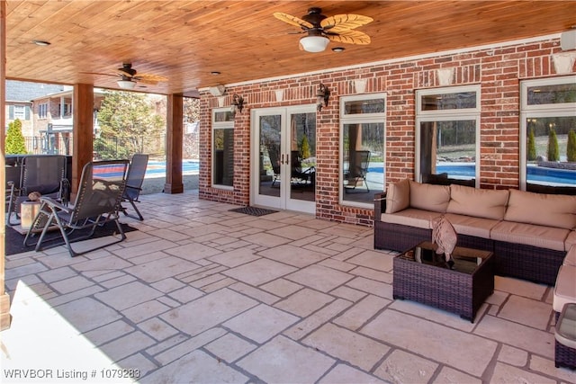 view of patio / terrace with french doors, an outdoor hangout area, ceiling fan, fence, and a swimming pool