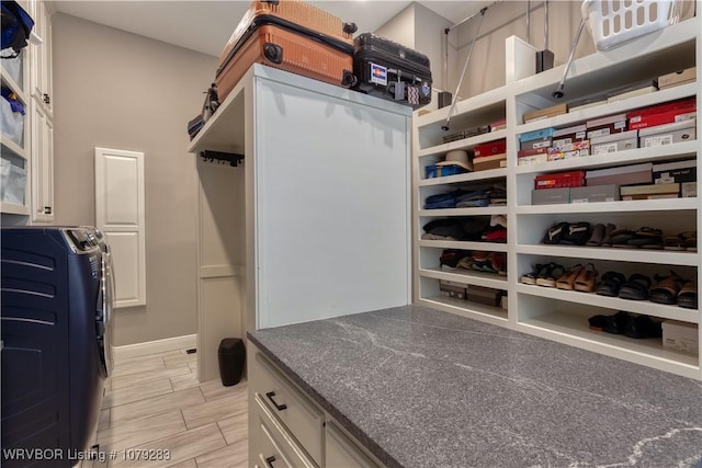 spacious closet with wood tiled floor and separate washer and dryer