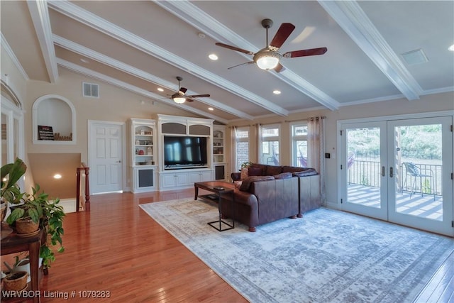 living area with light wood finished floors, visible vents, vaulted ceiling with beams, crown molding, and french doors