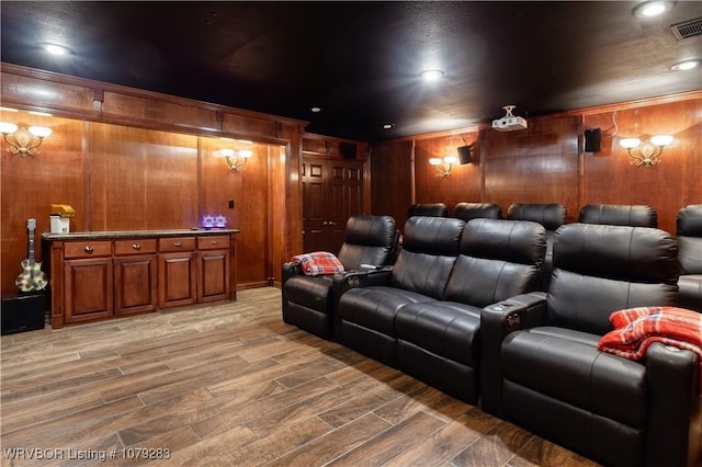 cinema room featuring light wood-type flooring, visible vents, and recessed lighting