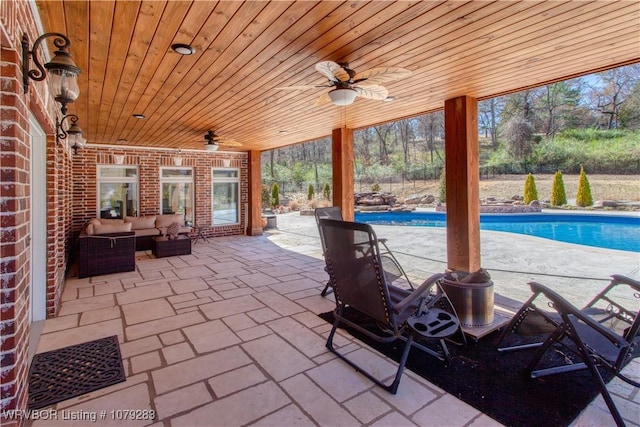 view of patio / terrace with an outdoor pool, an outdoor living space, and ceiling fan