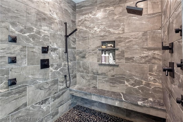 bathroom with tiled shower