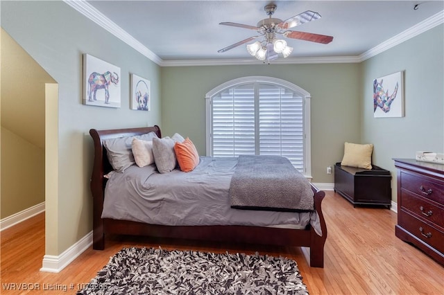 bedroom featuring baseboards, ceiling fan, light wood-type flooring, and crown molding