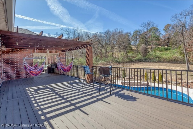 wooden deck featuring a fenced in pool