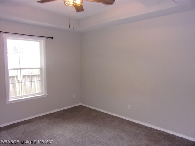 818 N 3rd St, Ozark, AR 72949 - spare room featuring a ceiling fan, dark carpet, and plenty of natural light