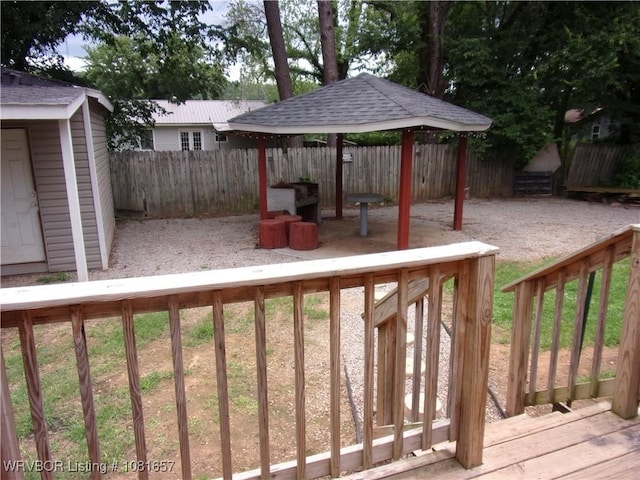 818 N 3rd St, Ozark, AR 72949 - deck featuring a gazebo, a fenced backyard, and a storage shed
