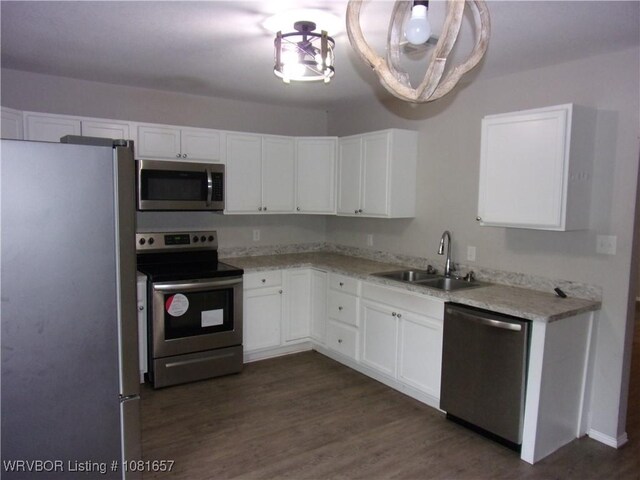 818 N 3rd St, Ozark, AR 72949 - kitchen featuring stainless steel appliances, white cabinetry, dark wood-type flooring, and light stone countertops