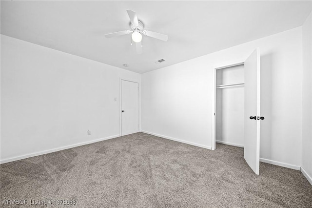 unfurnished bedroom with carpet flooring, ceiling fan, and a closet