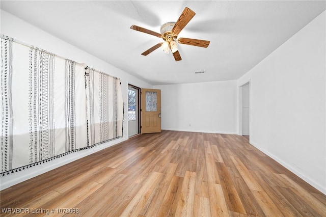 empty room featuring ceiling fan and light wood-type flooring