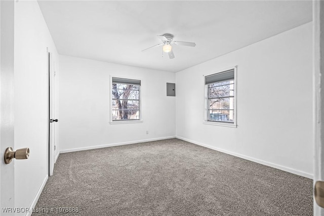 empty room with ceiling fan, carpet flooring, and electric panel