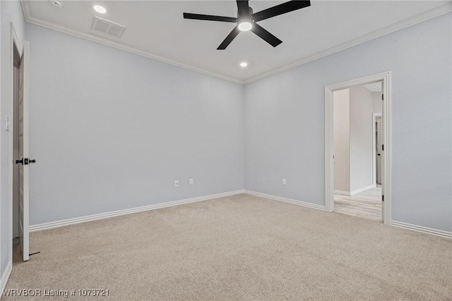 unfurnished room with light colored carpet, ceiling fan, and ornamental molding