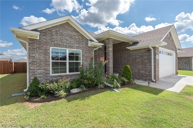 view of front of home with a front yard and a garage