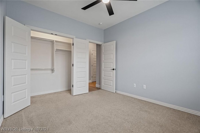 unfurnished bedroom with a closet, light colored carpet, and ceiling fan