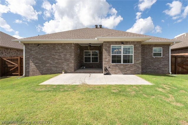 rear view of property with a lawn and a patio