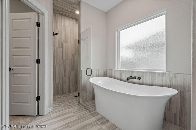 bathroom with independent shower and bath and tile walls