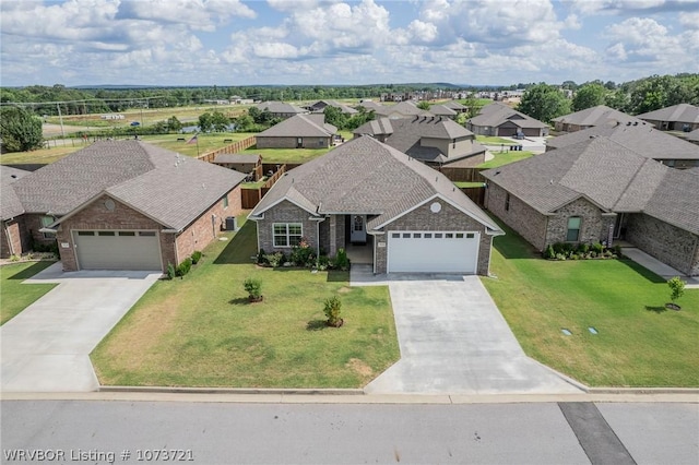 view of front of house featuring a front lawn and a garage