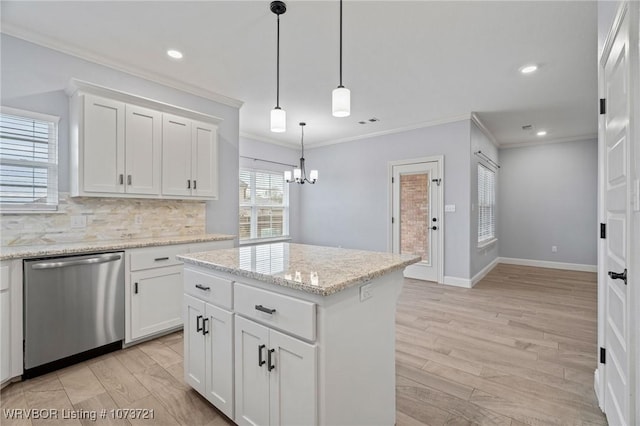 kitchen with dishwasher, a center island, white cabinetry, and crown molding