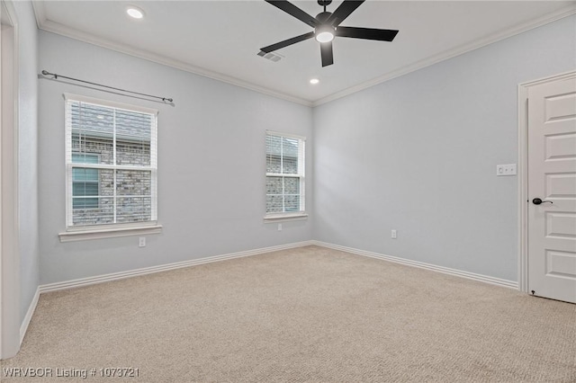 carpeted empty room featuring crown molding, plenty of natural light, and ceiling fan