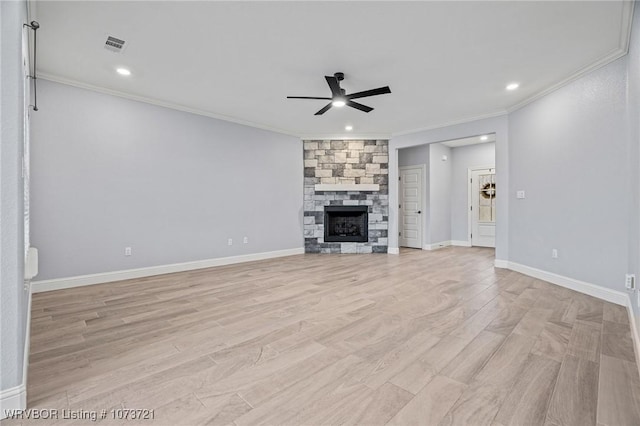 unfurnished living room with ceiling fan, a fireplace, light hardwood / wood-style floors, and ornamental molding