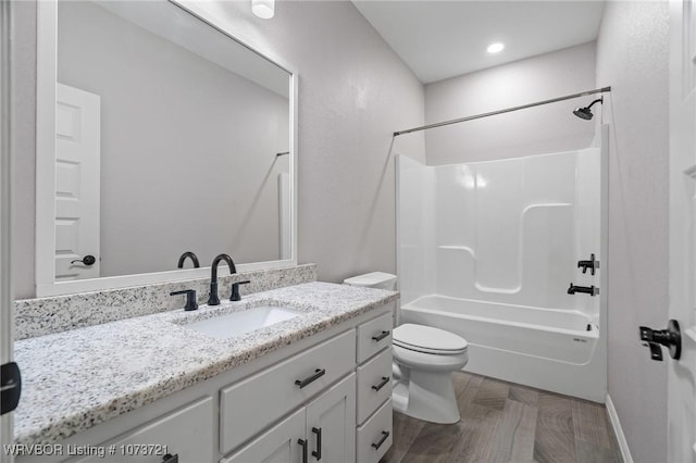 full bathroom featuring toilet, vanity, and washtub / shower combination