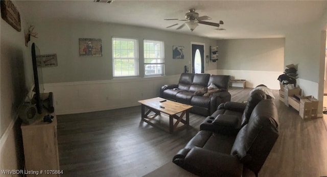 living room with ceiling fan and dark hardwood / wood-style floors