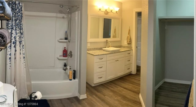 bathroom with hardwood / wood-style flooring, vanity, and shower / tub combo with curtain