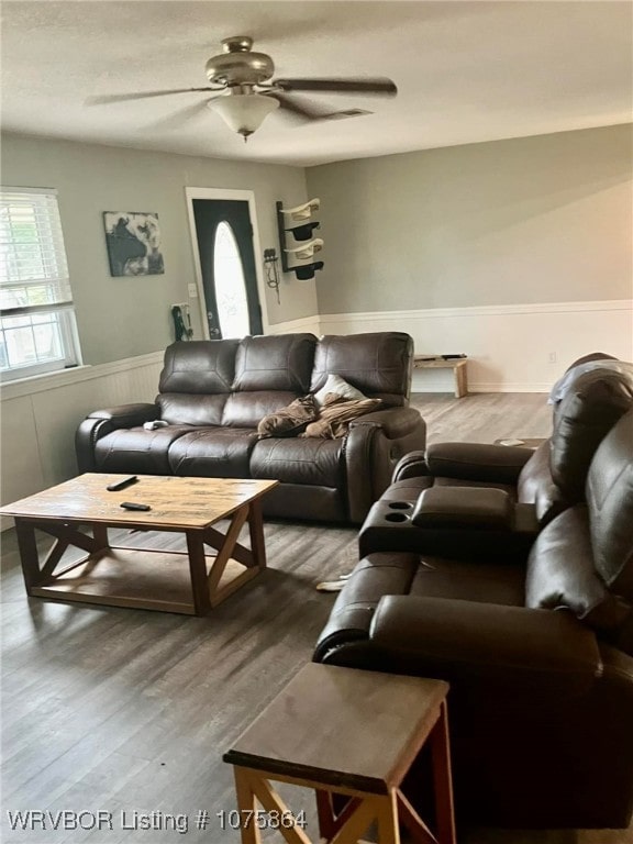 living room featuring hardwood / wood-style flooring and ceiling fan