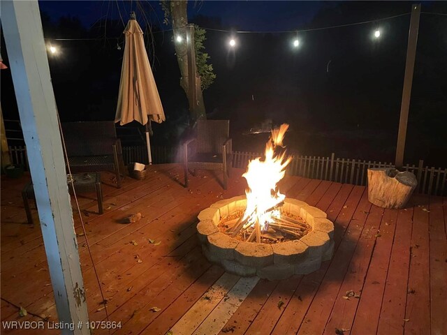 deck at night with a fire pit