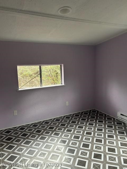 unfurnished room with a baseboard radiator