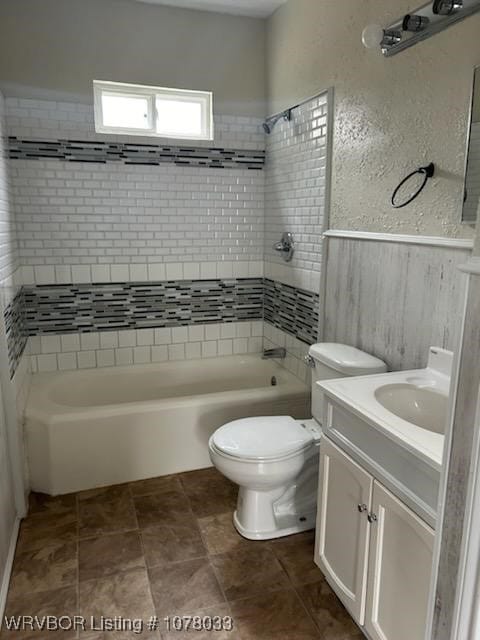 full bathroom featuring toilet, vanity, and tiled shower / bath