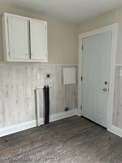 laundry room featuring dark hardwood / wood-style flooring and cabinets