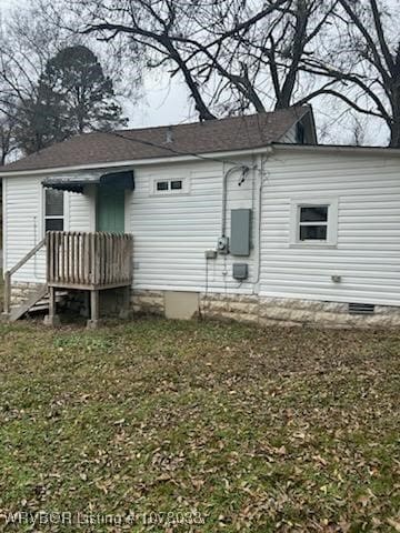 back of property featuring a lawn