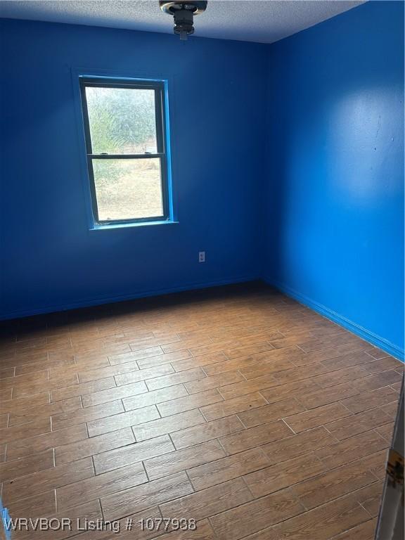 spare room with a textured ceiling