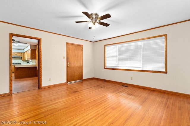 unfurnished bedroom featuring ensuite bath, ornamental molding, and light hardwood / wood-style flooring