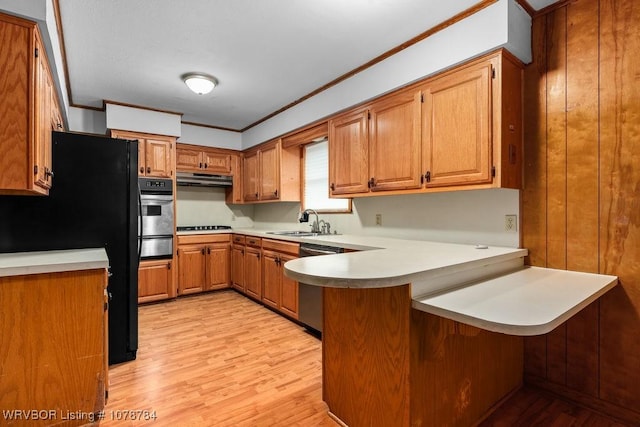 kitchen featuring black appliances, sink, ornamental molding, kitchen peninsula, and light wood-type flooring