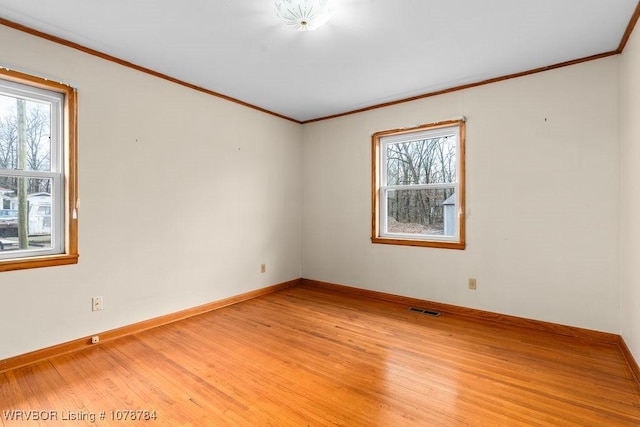 spare room with hardwood / wood-style flooring and ornamental molding