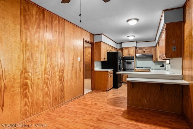 kitchen with sink, crown molding, black refrigerator with ice dispenser, and light wood-type flooring